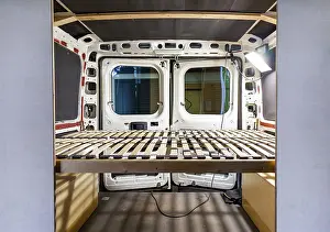 Images Dated 19th June 2024: DIY Camper Van Conversion Print: Handcrafted Bed Frame