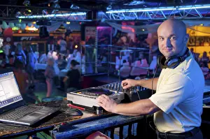 Disc Jockey Equipment Prints: DJ behind the control panel vinyl records