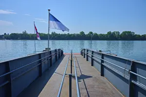 Rhine River Germany Prints: Dock on the river, flags fly in the wind under a clear sky