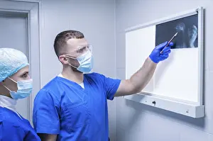 Medical Practitioner Prints: Two doctors are examining an X-ray