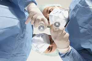 Healthcare Professionals Teamwork Prints: Two doctors getting ready to administer an injection