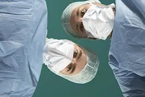 Doctor Patient Interaction Prints: Two doctors looking down at a patient