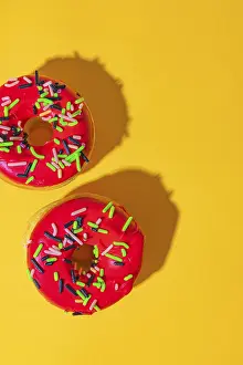 Plain Yellow Background Images Prints: Donuts on yellow background with red icing