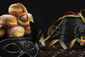 Plain Colored Background Cutout Prints: Doughnuts against a dark background next to a black hat