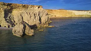 Greek Islands Landscape Prints: Dramatic cliff landscape with calm blue water