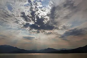 Dramatic Cloud Formation Prints: Dramatic cloud formation, sunbeams behind dark clouds
