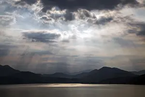 Dramatic Cloud Formation Prints: Dramatic cloud formation, sunbeams behind dark clouds
