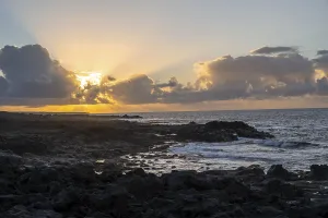 Spanish Rocky Coast Prints: Dramatic cloudy sky with sunbeams at sunset