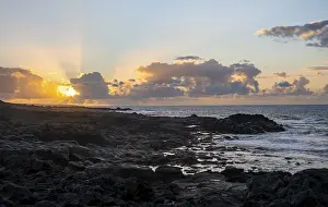 Spanish Coastline Prints: Dramatic cloudy sky with sunbeams at sunset