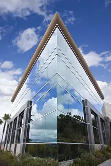 High Rise Structure Prints: Dramatic corporate building with blue sky and clouds