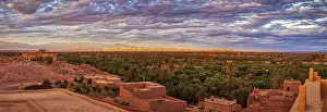 Maghreb States Scenery Prints: Dramatic desert panorama with oasis and mountains in the background at sunset