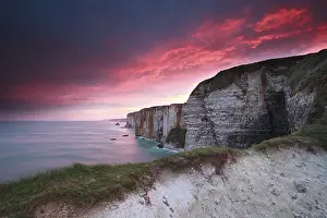 Rocky Coastline Photography Prints: Dramatic fire sunrise over cliffs in ocean