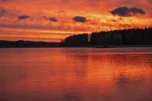 Frozen Lake Landscape Prints: A dramatic sunset over a still