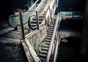 Desolate Urban Landscape Prints: Dramatic view of damaged escalators in abandoned building