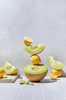 Vibrant Fruit Display Prints: A dynamic arrangement of melons and lemons on a tiled surface