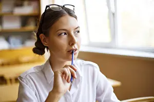 Student Learning Environment Prints: Education in classroom concept image student writing article or notes in lecture room while participating in study