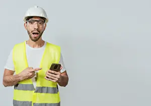 Construction Industry Professional Prints: Engineer using and pointing at cellphone
