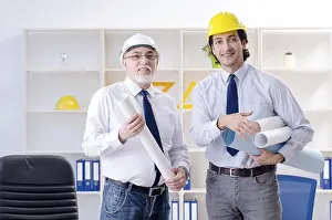 Two People Working Together Prints: Two engineers colleagues working under project