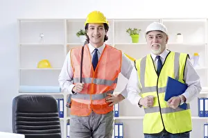 One Person Working Prints: Two engineers colleagues working under project