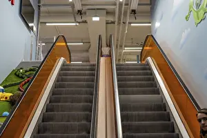 Images Dated 13th April 2024: Top of an Escalator Print with Orange Glass Railing