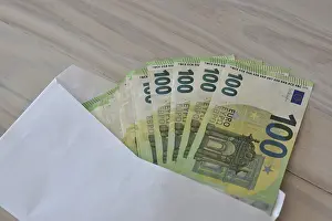 Corruption Symbol Prints: Many one hundred euro notes in an envelope on a table