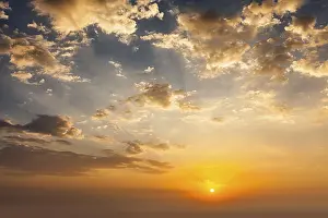 Dramatic Sunset Sky Prints: Evening sunset sky with sun and dramatic clouds