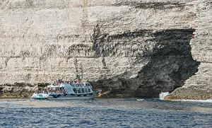 Rocky Coastline Photos Prints: Excursion boat visiting cave in chalk cliffs