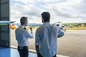 Aircraft Maintenance Hall Prints: Experienced pilot instructor mentoring a young student or trainee