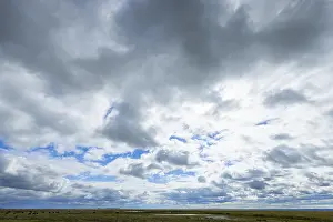 Cloud Formations Prints: Extensive cloud formations move across the blue sky