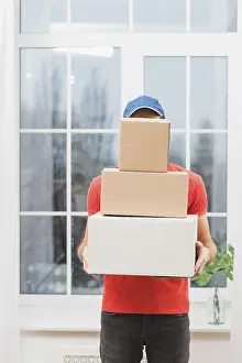 Parcel Delivery Prints: Faceless courier with stack parcels