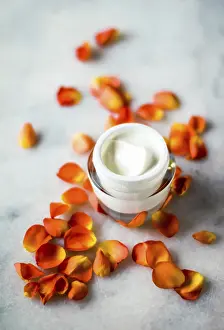 Anti Aging Skincare Prints: Facial treatment, anti aging skincare and spa concept - Beauty face moisturizing cream and flower petals on marble