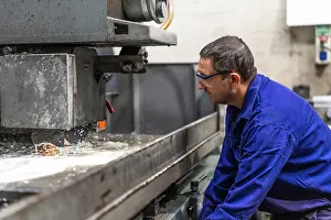 Factory Worker Prints: Factory worker operator in the numerical control sector preparing a machine