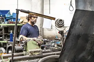 Factory Worker Prints: Factory worker operator in the numerical control sector working on a machine