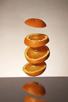 Studio Shot Of Sliced Oranges Prints: Falling orange slices