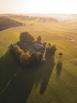 Evening Light Landscape Prints: A farm surrounded by fields and trees in the evening light