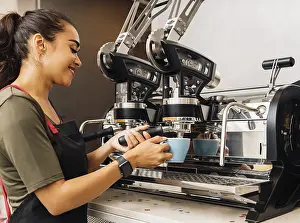 Barista At Work Prints: Female barista using a coffee machine