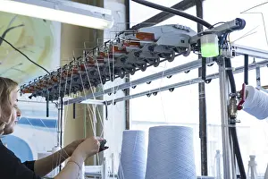Industrial Building Architecture Prints: Female operator working at thread rewinding machine cropped view