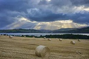 Agricultural Landscape UK Prints: Field with bales of straw under a sky full of dramatic rays of light