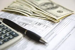Deserted Office Space Prints: Financial documents and tools with a calculator