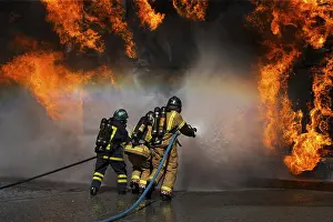 Firefighter In Action Prints: Fireman working against flames