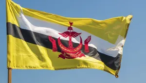 Prints of The flag of Brunei flutters in the wind, isolated against a blue sky Related Prints: The Flag of Brunei Print - Blue Sky