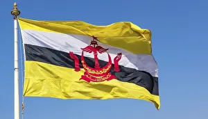 Prints of The flag of Brunei flutters in the wind, isolated against a blue sky Related Prints: The Flag of Brunei Print