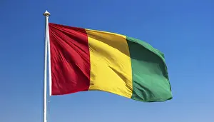 Flag Fluttering In Wind Prints: The flag of Guinea, fluttering in the wind