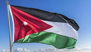 Middle East Travel Images Prints: The flag of Jordan flutters in the wind