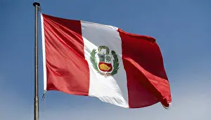 Blue Sky With Flag Isolated Prints: The flag of Peru flutters in the wind