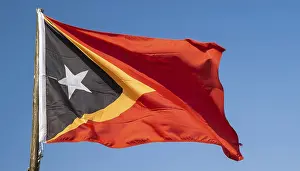 Blue Sky With A Flapping Flag Prints: The flag of Timor, fluttering in the wind