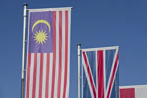Blue Sky With Flags Prints: Several flags of different countries fly side by side under a clear blue sky