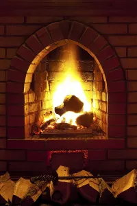Fire In Fireplace Prints: Flames of fire in fireplace in evening time