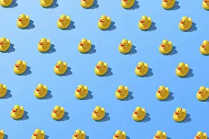 Text Free Space For Copy Prints: Flat lay of a creative summer yellow rubber duck pattern