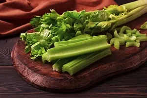 Dark Background Vegetables Prints: Fresh bunch of celery, top view